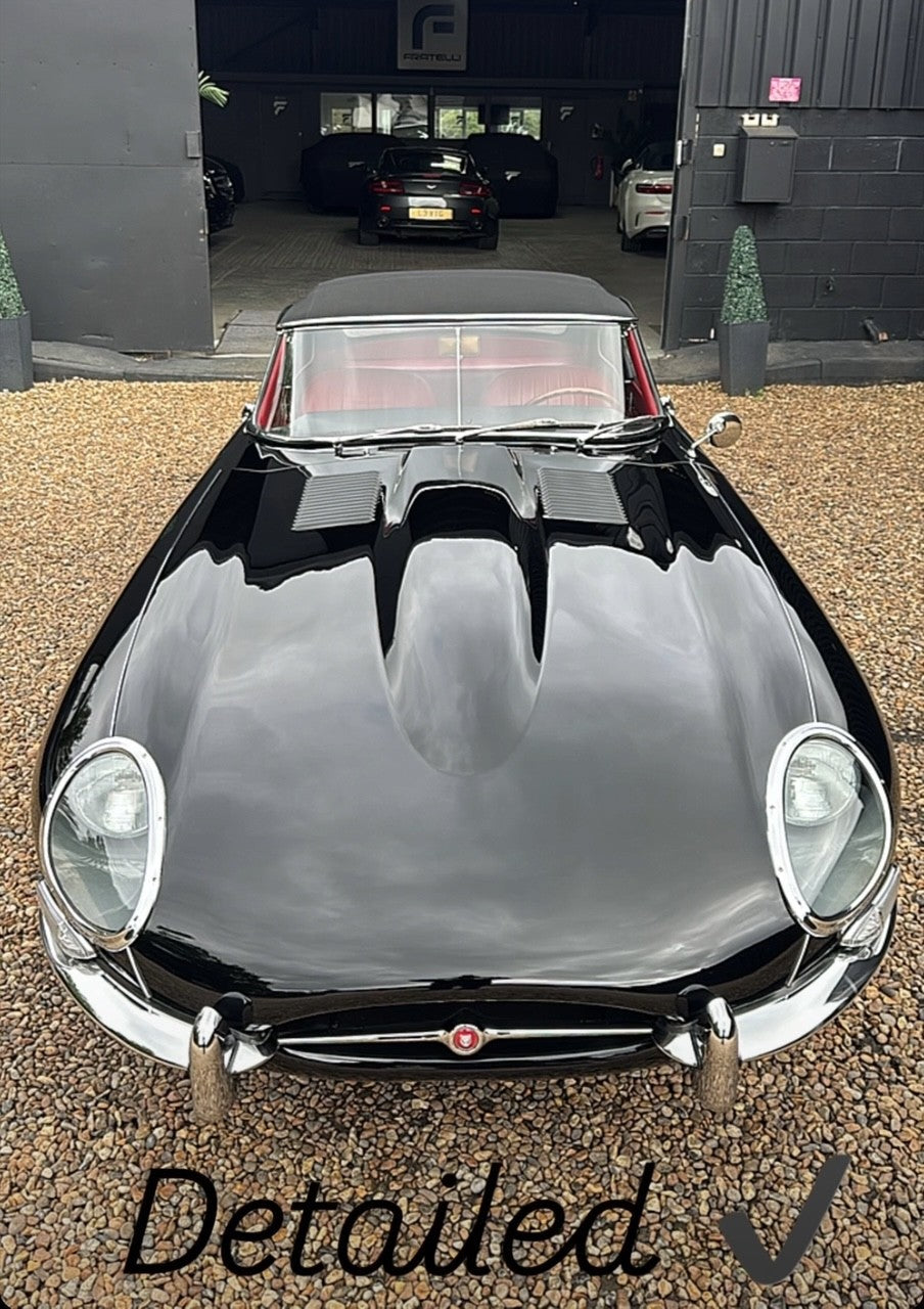 Classic car detailing on a 1961 Jaguar E-Type Series 1 at FX Detailing Surrey. Image shows restored Jaguar Black paint and polished chrome wire wheels following a preservation detail in our Charlwood studio.