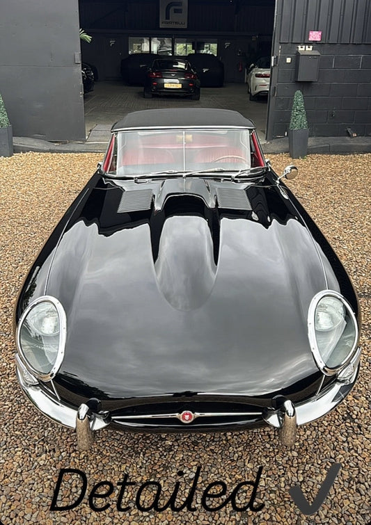 Classic car detailing on a 1961 Jaguar E-Type Series 1 at FX Detailing Surrey. Image shows restored Jaguar Black paint and polished chrome wire wheels following a preservation detail in our Charlwood studio.