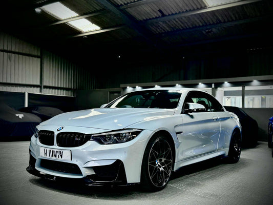 Professional BMW bodykit installation at FX Detailing Surrey. Image shows the 1 Series and M4 carbon fibre splitter fitment and pricing guide for our Charlwood studio.