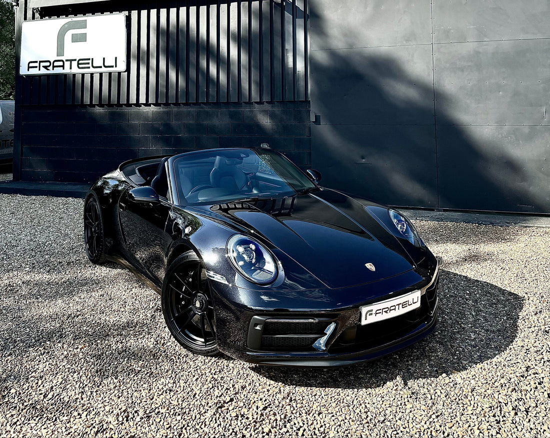 Specialist machine polishing and paint correction on a black Porsche at FX Detailing Surrey. Image shows the removal of swirl marks and holograms using professional lighting in our Charlwood studio.