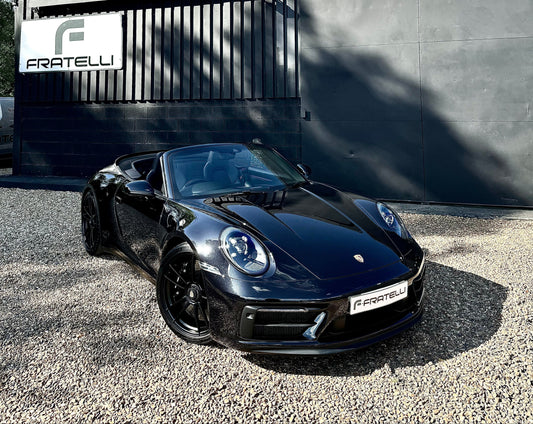 Specialist machine polishing and paint correction on a black Porsche at FX Detailing Surrey. Image shows the removal of swirl marks and holograms using professional lighting in our Charlwood studio.