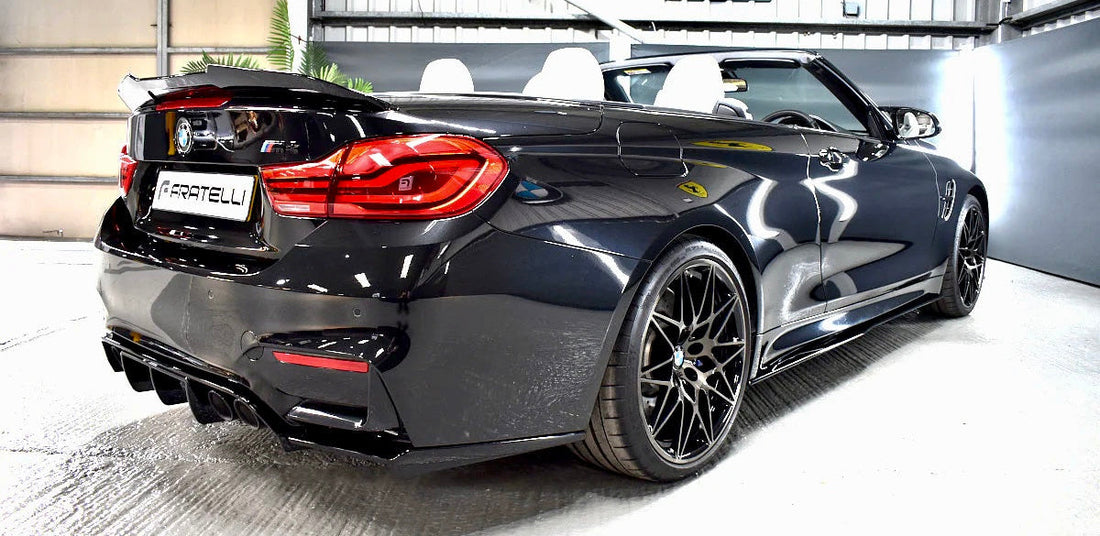 Full bodykit installation on a Sapphire Black BMW M4 Competition at FX Detailing Surrey. Image showcases the integrated rear diffuser and quad-exhaust alignment in our Charlwood studio.