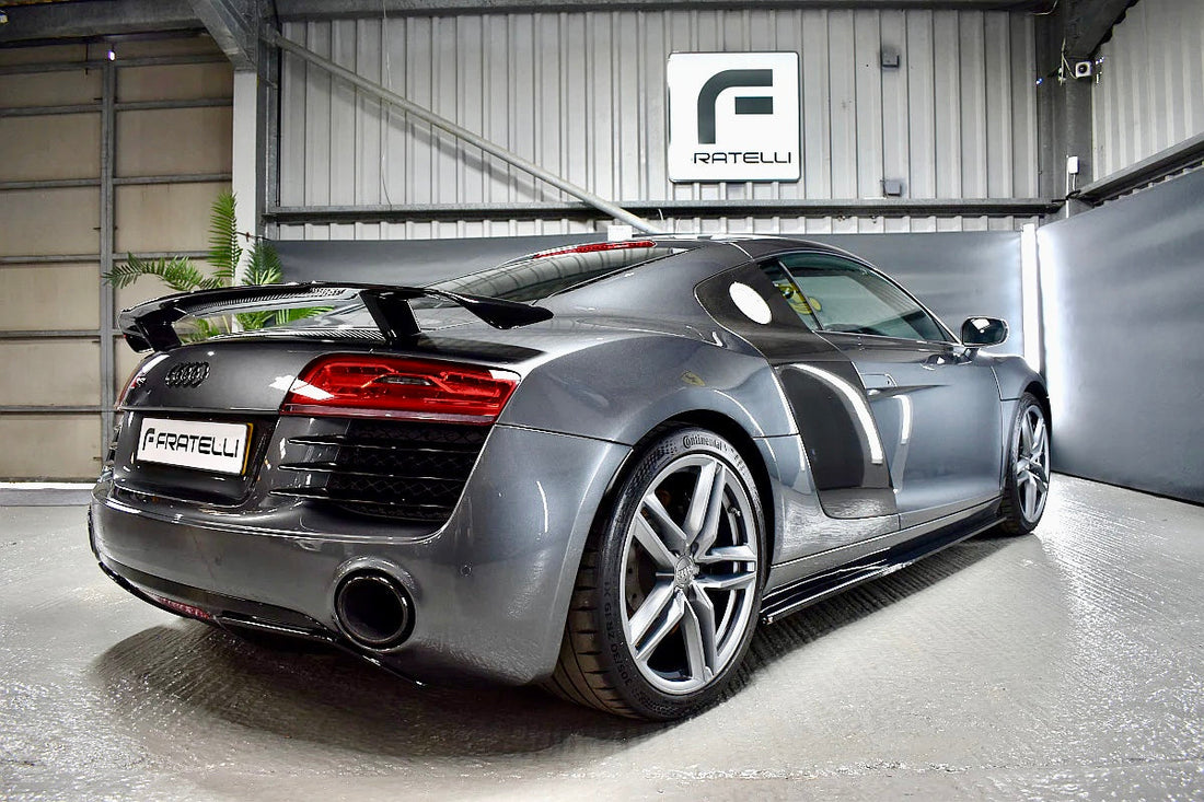 Precision carbon fibre rear spoiler installation on an Audi R8 V10 at FX Detailing Surrey. Close-up of symmetrical alignment and flush fitment in our Charlwood studio.