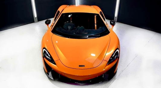 Comparing car valeting vs professional car detailing at FX Detailing Surrey. Image shows the precision machine polishing process used to restore paint clarity in our Charlwood studio.