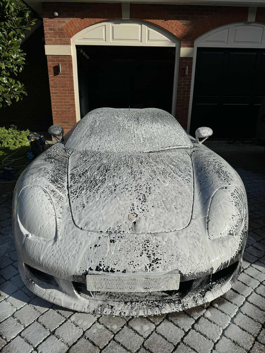 Safe pH-neutral car detailing products being used on a luxury vehicle at FX Detailing Surrey. Image shows pH-neutral snow foam application in our Charlwood studio to protect the ceramic coating and paintwork.