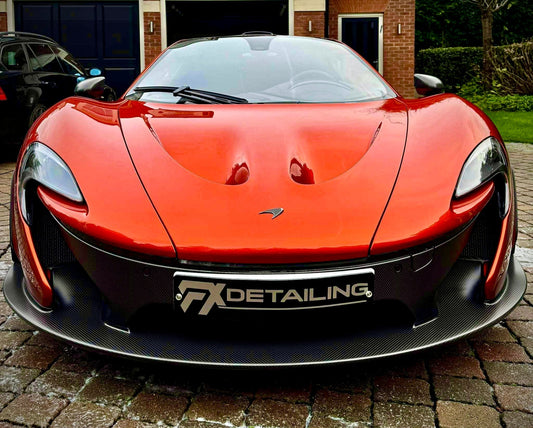 Pricing guide for luxury car detailing and paint correction in Surrey and London. Image shows specialist machine polishing on a supercar door panel at FX Detailing studio.