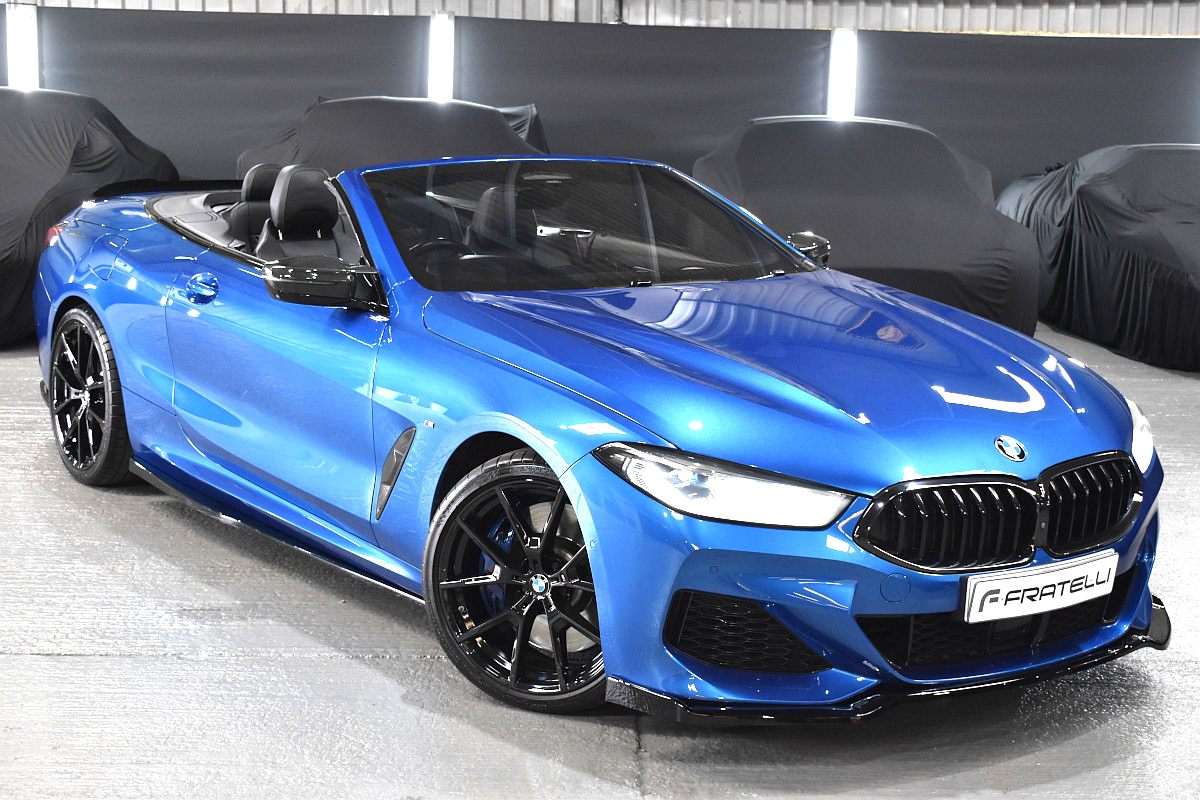 Blue BMW 850i convertible with a front splitter and side skirt