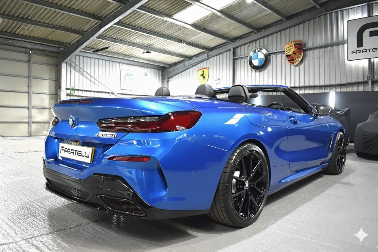 Rear three-quarter of a blue BMW 850i convertible before the side skirt