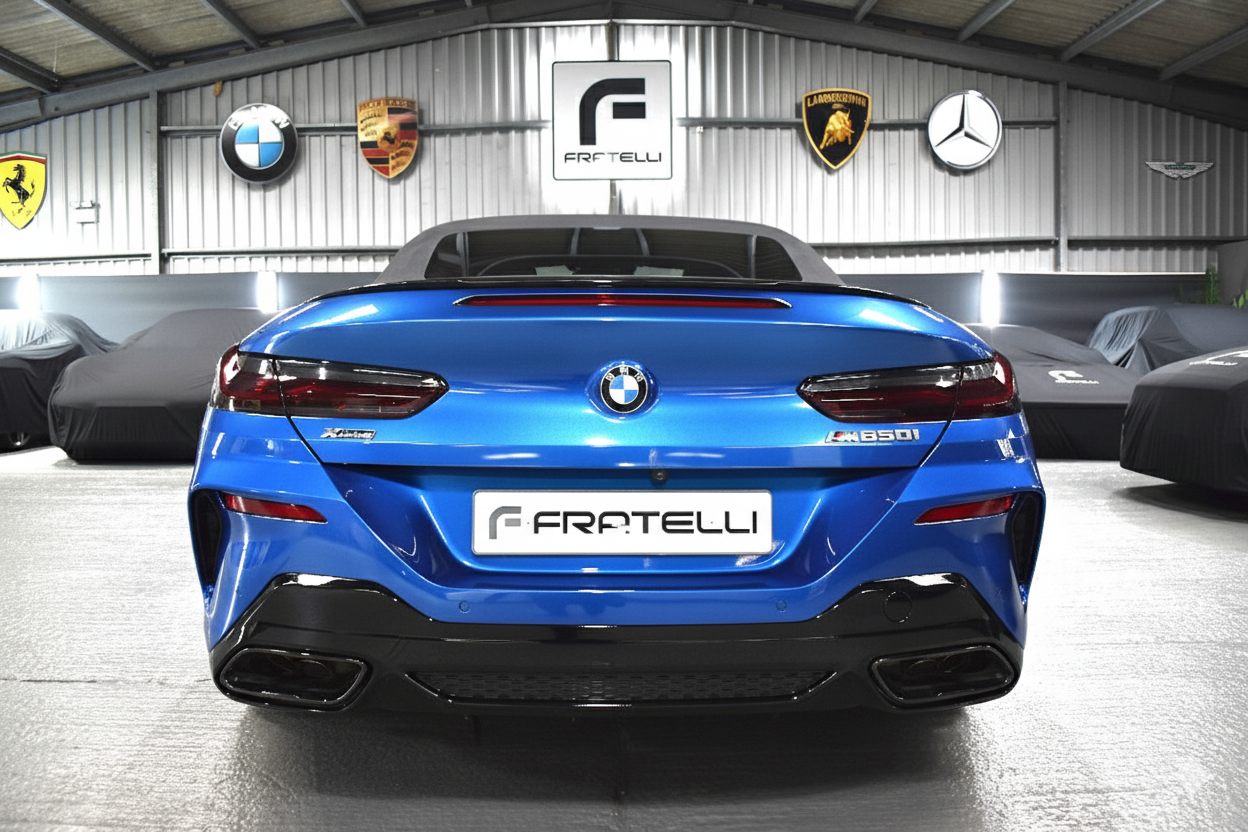 Rear of a blue BMW 850i convertible with a diffuser and quad exhausts