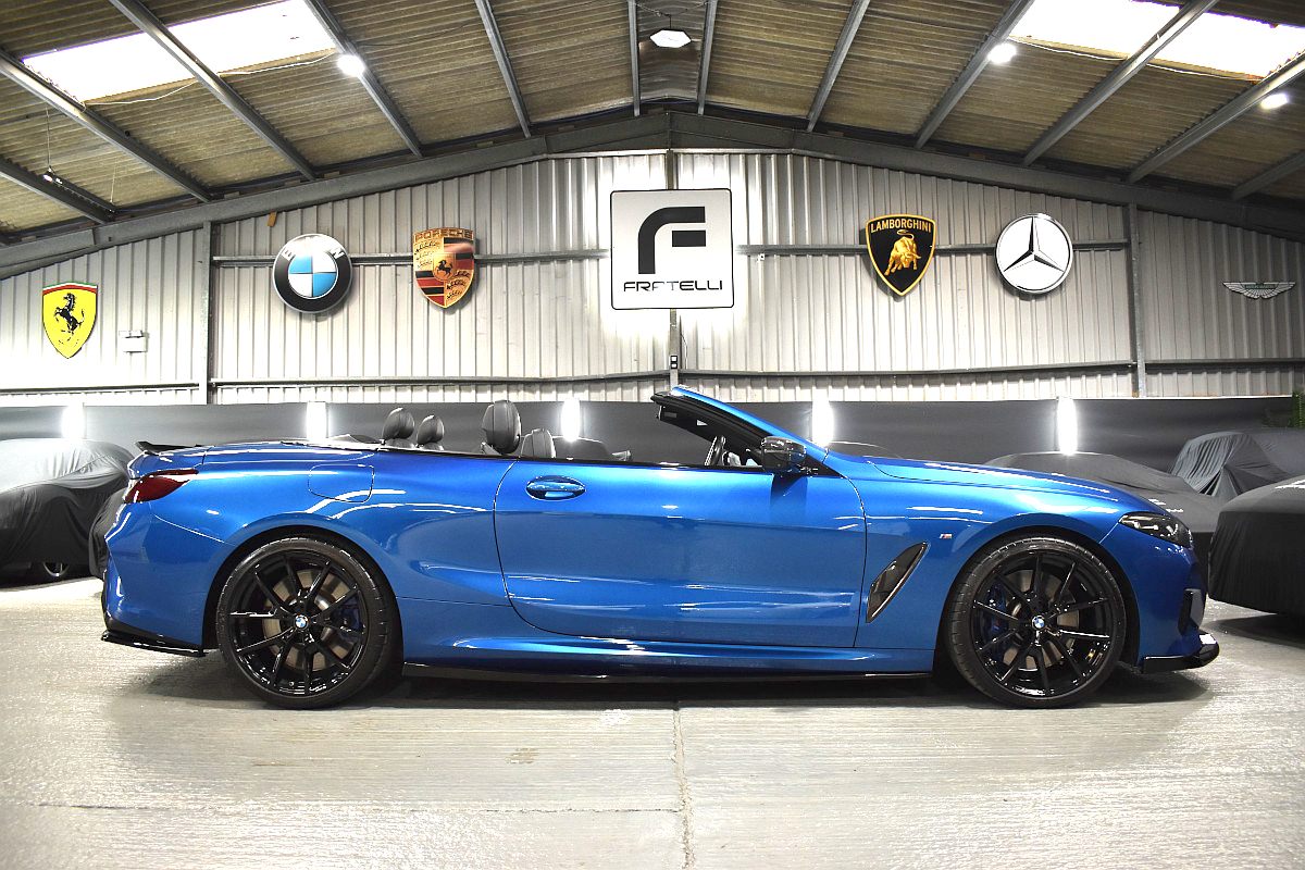 Side of a blue BMW 850i convertible with side skirts