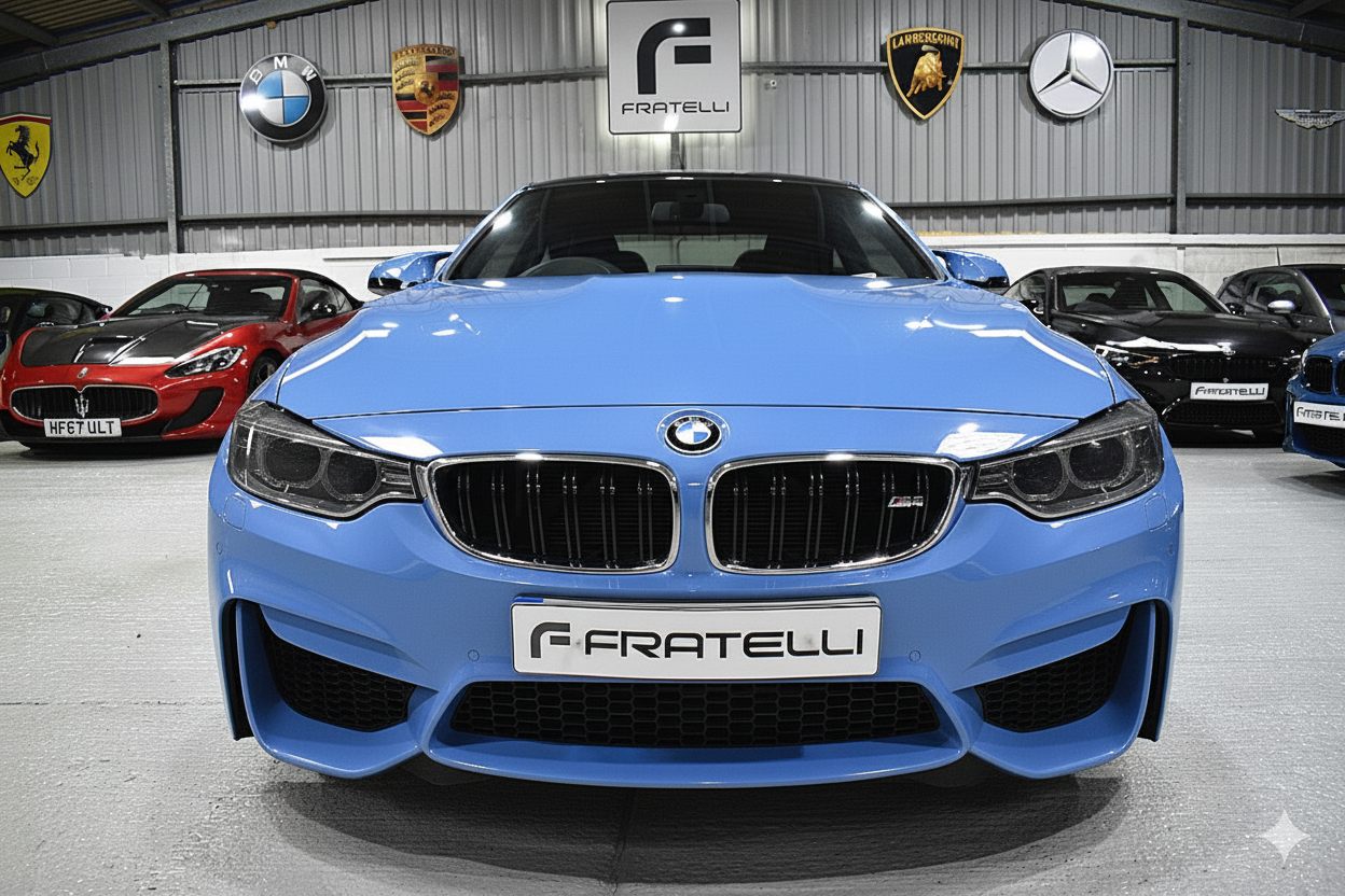Front of a light blue BMW M4 before the carbon splitter
