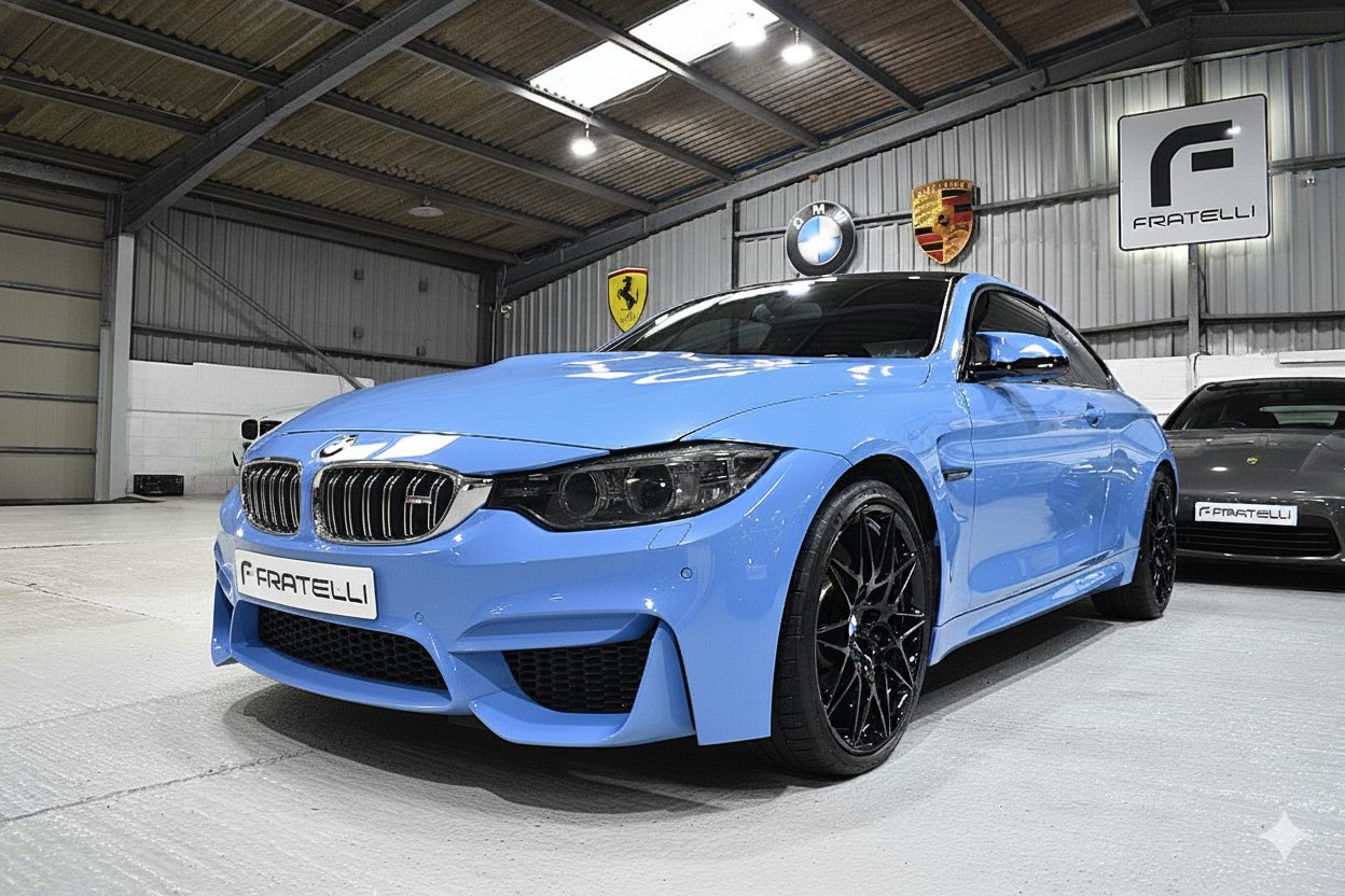 Light blue BMW M4 coupe before the front splitter and side skirt
