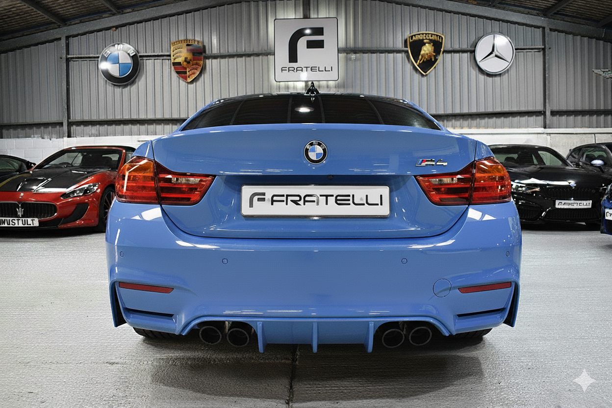 Rear of a light blue BMW M4 before the spoiler and diffuser