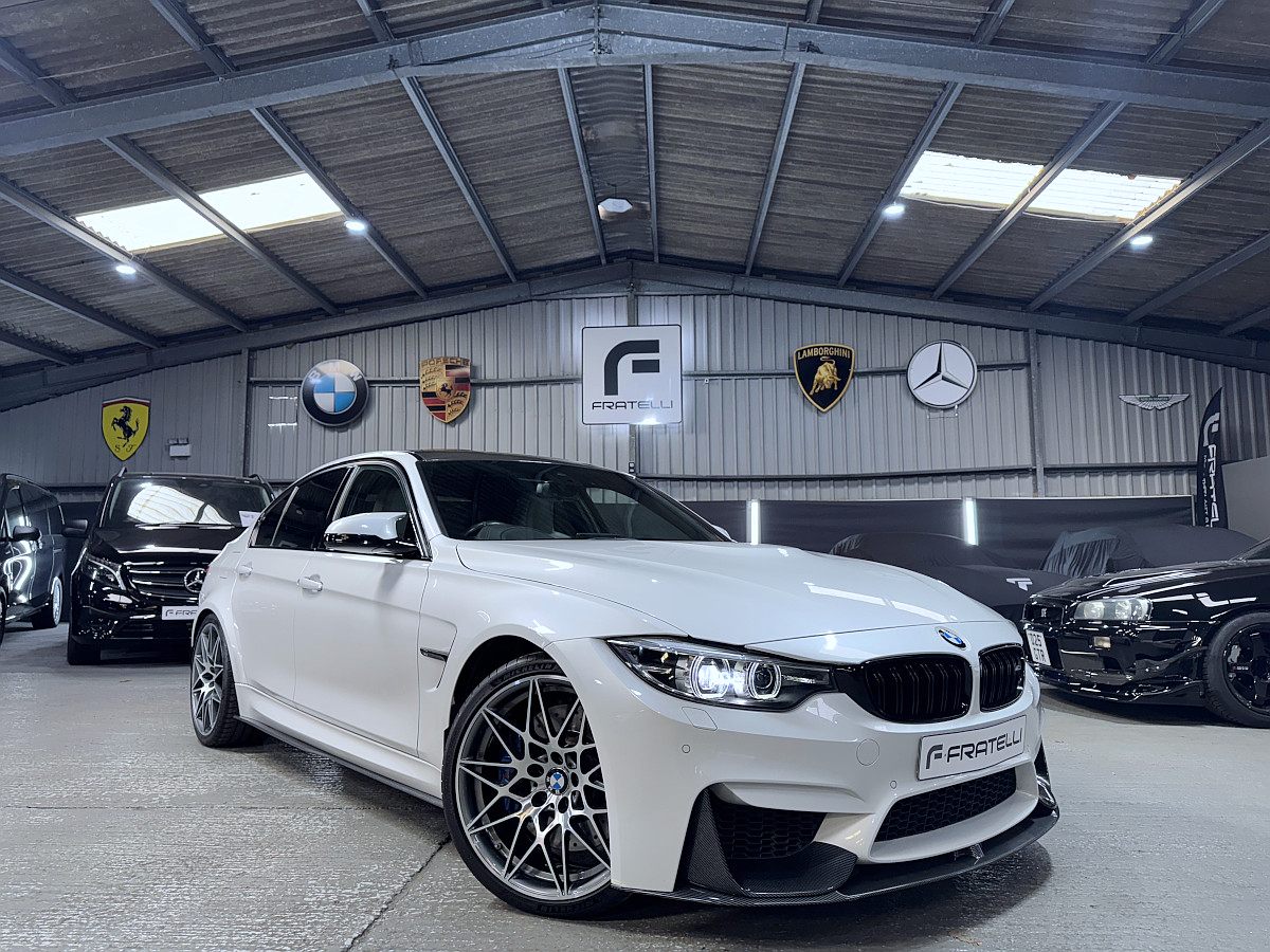White BMW M3 saloon with a carbon front splitter and side skirt
