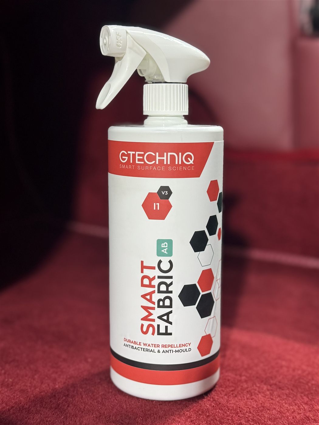 Gtechniq I1 Smart Fabric bottle on red fabric